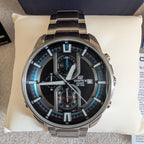 Stainless steel chronograph watch with black dial, blue markers, and multi-dial layout