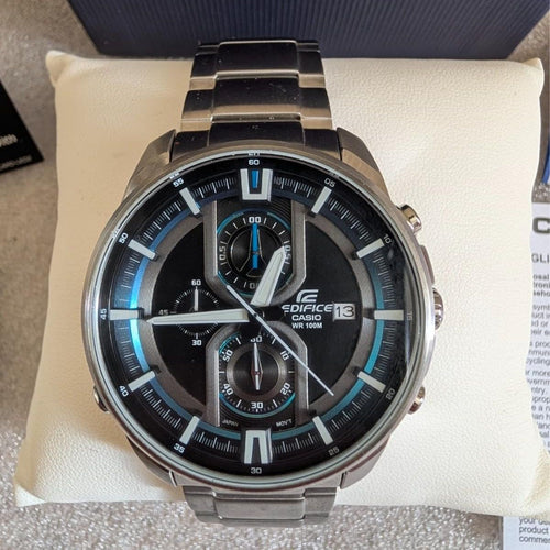 Stainless steel chronograph watch with black dial, blue markers, and multi-dial layout
