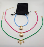 Beaded choker necklace set with starfish and seashell charms in green, pink, blue