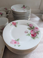 Porcelain dinner plates with pink rose sprig design and thin gold rim, stacked