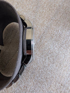 Military style watch side view with crown and polished steel case