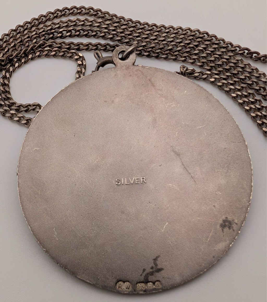 Sterling silver round pendant back with 'SILVER' stamp and link chain