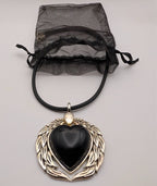 Black heart pendant necklace with silver winged setting and black cord