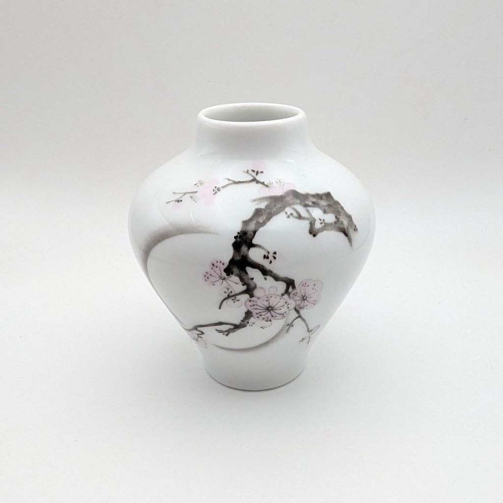 Porcelain bud vase with cherry blossom branch motif, white with pink accents