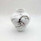 Porcelain bud vase with cherry blossom branch motif, white with pink accents