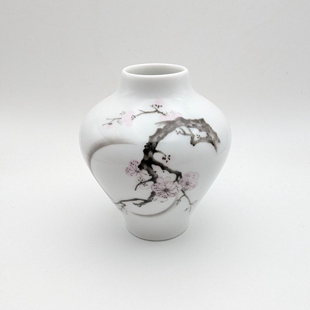 Porcelain bud vase with cherry blossom branch motif, white with pink accents