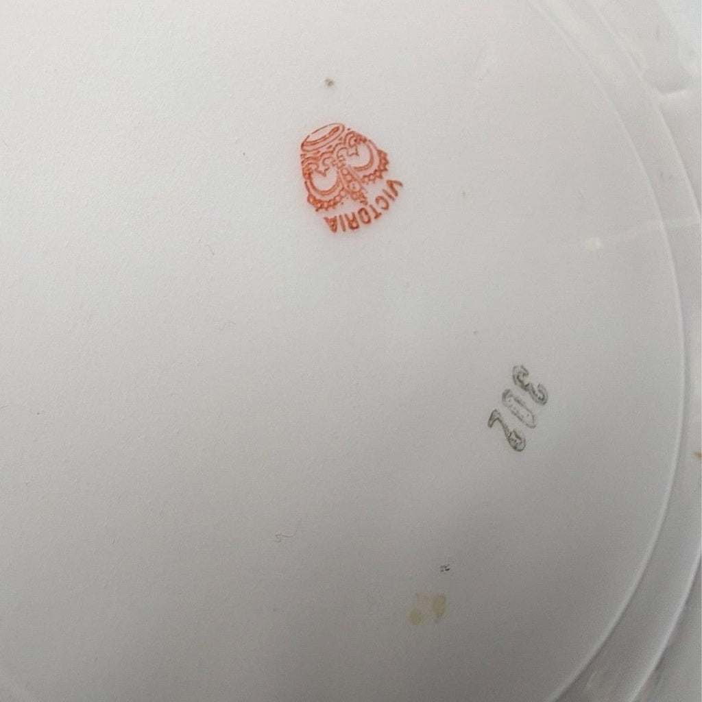 Porcelain plate underside, white back with red maker mark and faint model numbers