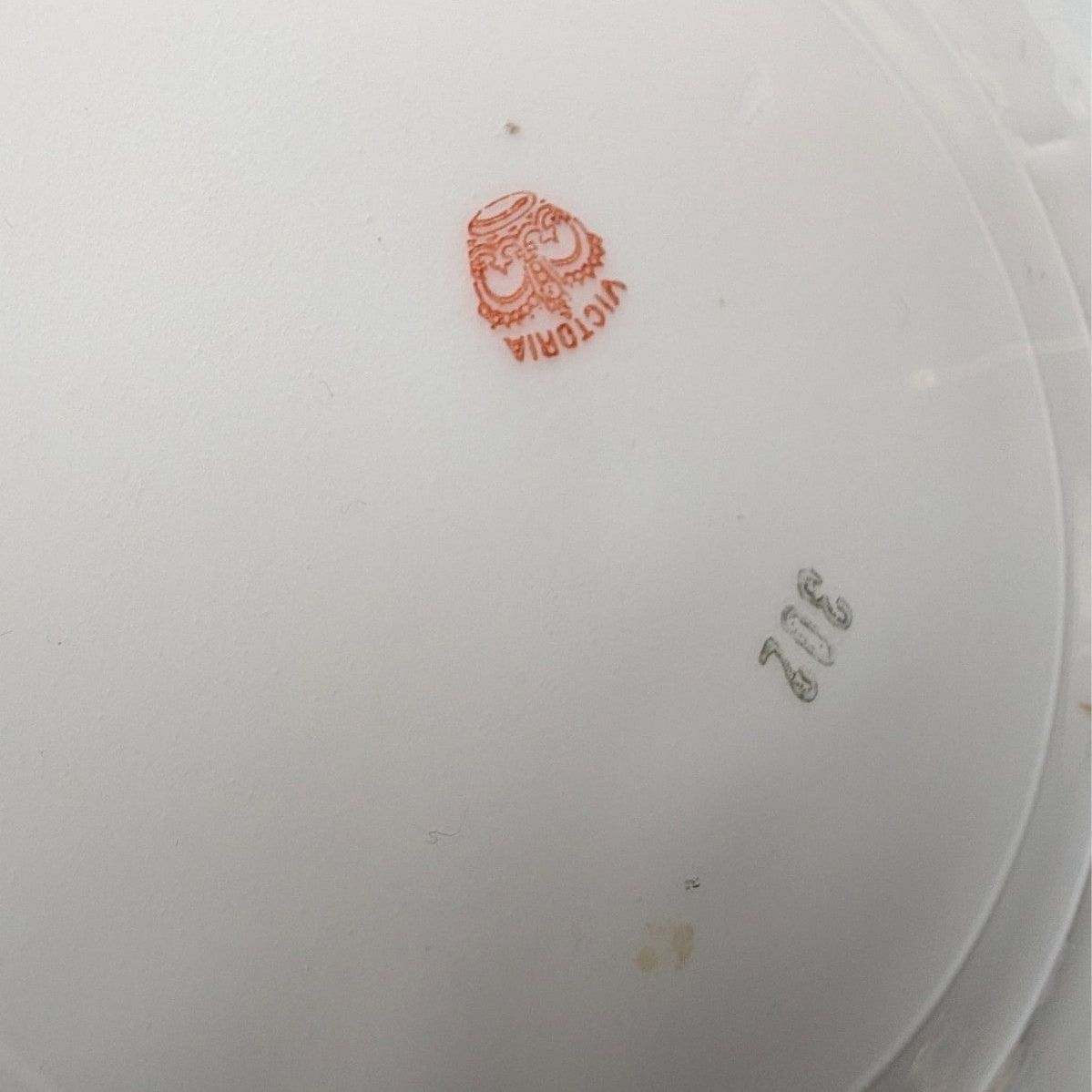 Porcelain plate underside, white back with red maker mark and faint model numbers