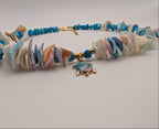 Turquoise and multicolor shell choker with turtle charm at center