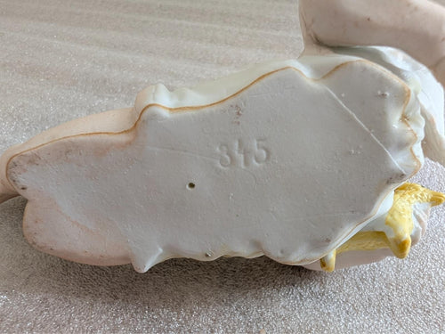 Porcelain baby figurine base with stamped number 375 on underside