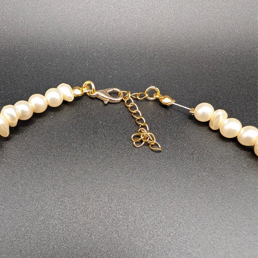 Pearl beaded choker clasp with gold-tone chain links and adjustable extender
