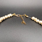 Pearl beaded choker clasp with gold-tone chain links and adjustable extender