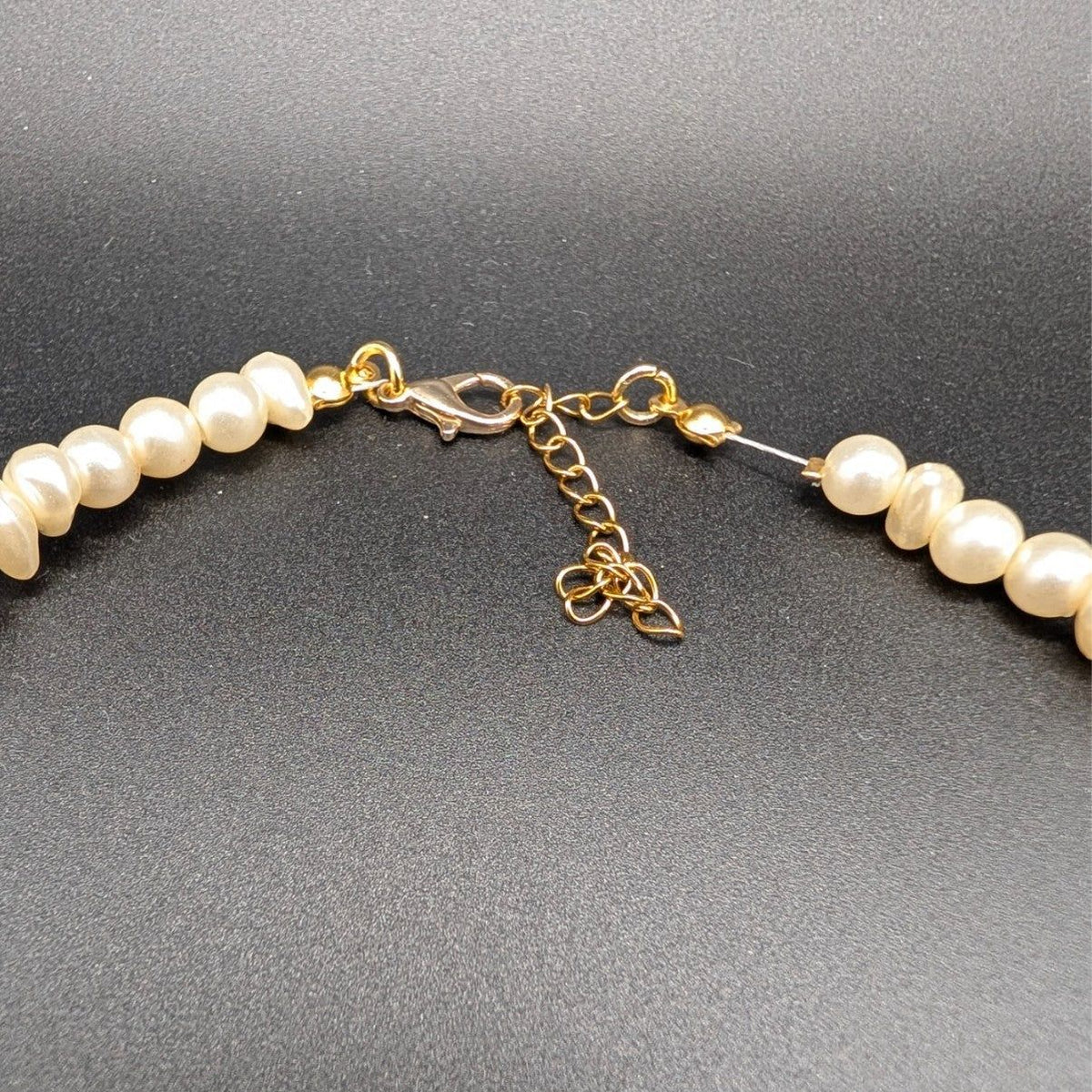 Pearl beaded choker clasp with gold-tone chain links and adjustable extender