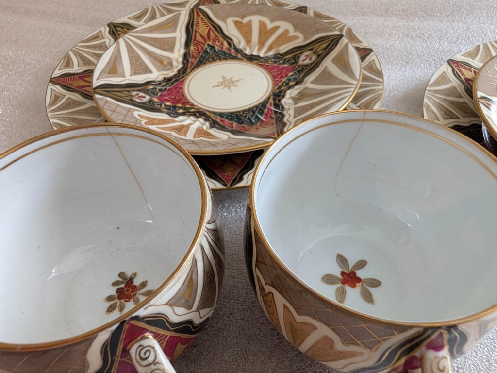 Decorative porcelain plates with multicolor geometric trim and small flower motif