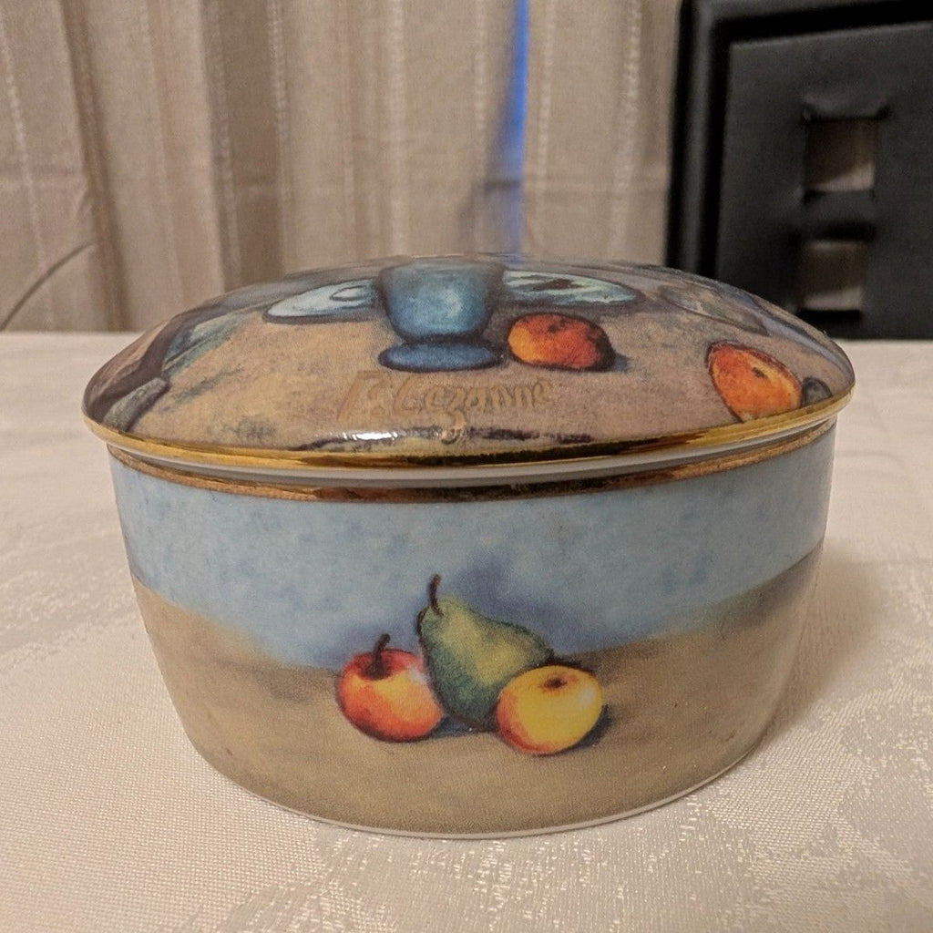 Porcelain trinket box with blue vase and fruit still-life, round hinged lid