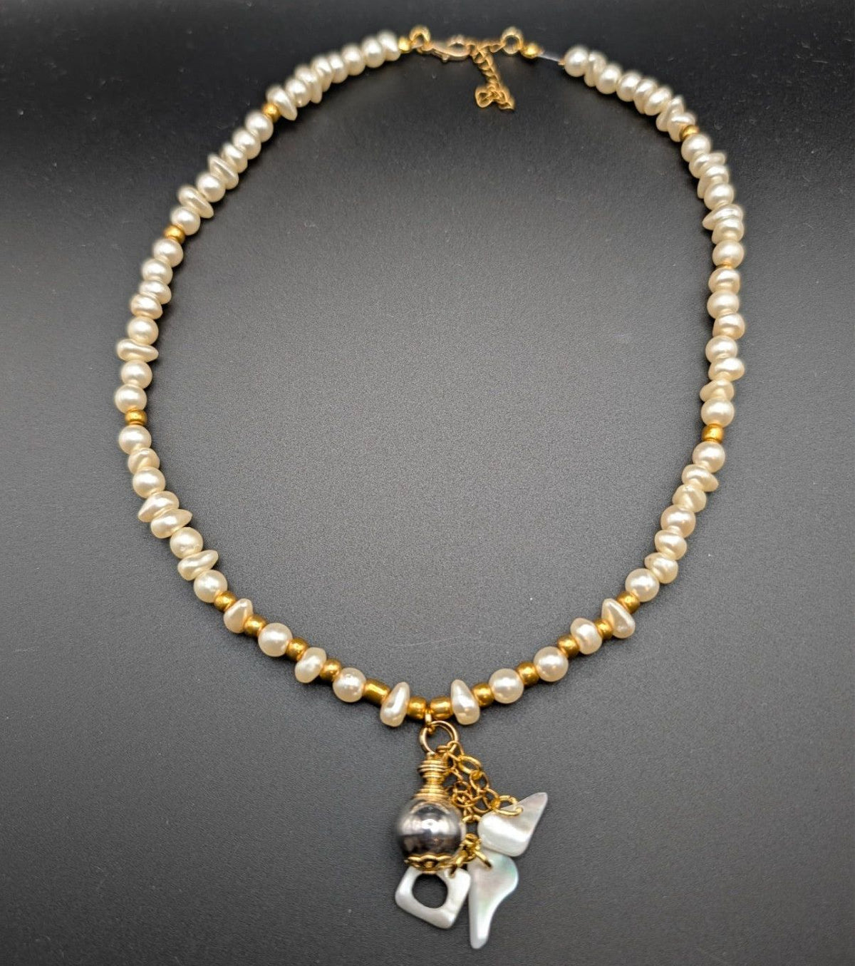 Gold-tone pearl choker with round beads and small mother-of-pearl style charm pendant
