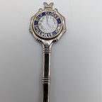Silver collector spoon top with round "Billy Clock" medallion