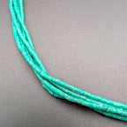Turquoise multi-strand beaded necklace close-up of textured bead rows