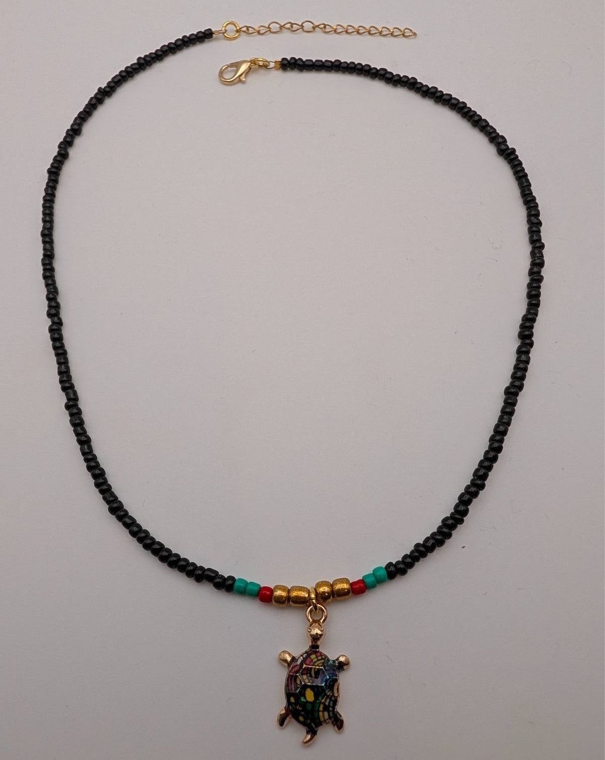 Black beaded sea turtle choker necklace with multicolor gold-tone turtle pendant