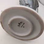Underside of porcelain robin bird figurine with oval stamp and raised base