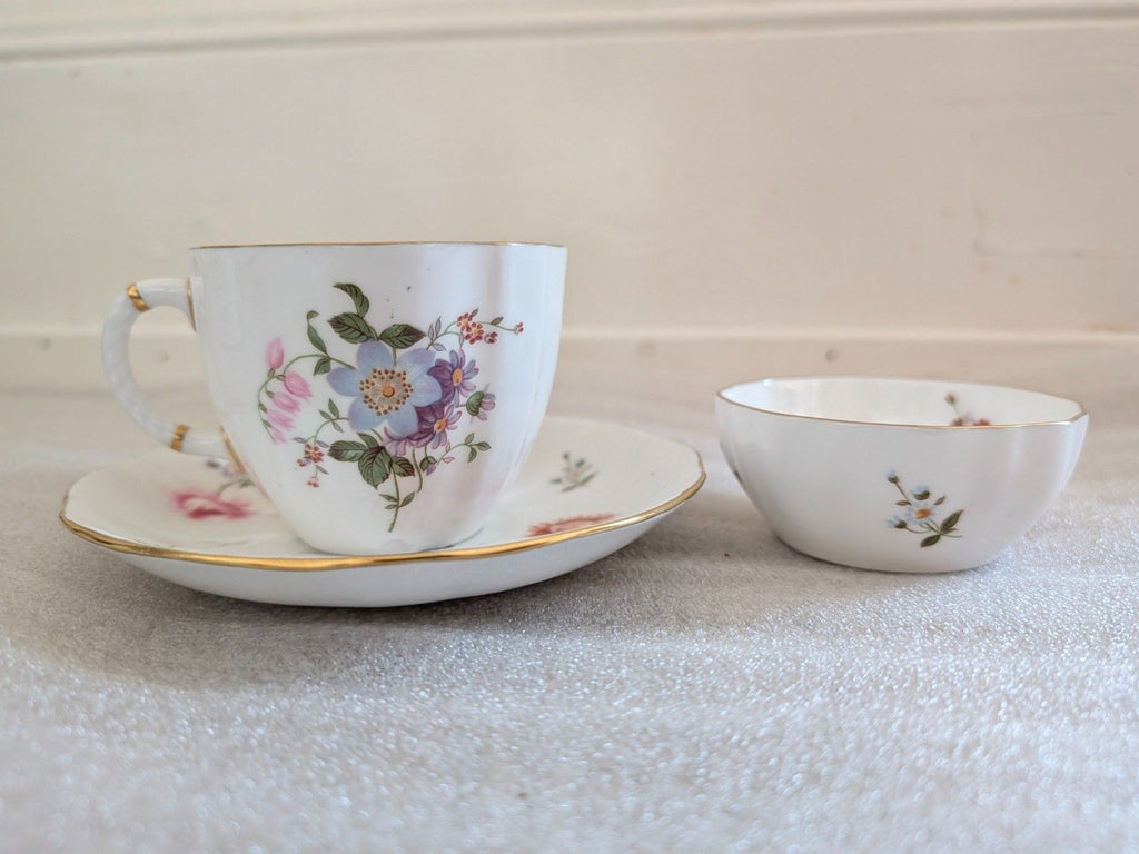 Bone china teacup and saucer with posies floral print and gold edge