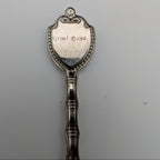 Souvenir metal spoon with engraved 'FORT USA' on back of oval crest
