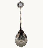Silver souvenir collector spoon with engraved Iowa scenes on the bowl
