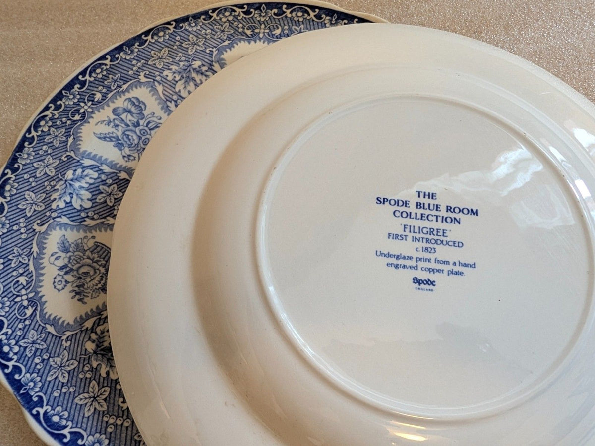 White porcelain dinner plate base with blue rim and printed maker mark
