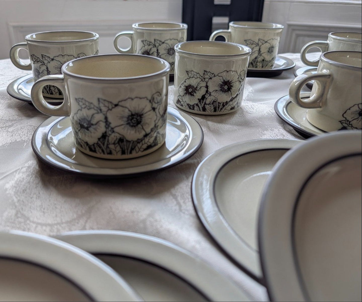 Stoneware tea set with floral cups and saucers, cream with blue-black pattern