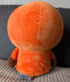 Orange hooded plush toy, back view with brown arms and hanging tie detail
