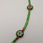 Green glass bead choker with turtle-shaped millefiori bead and red spacer beads