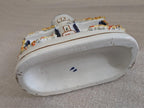 Ceramic cottage pastille burner base with curved rim and small blue mark