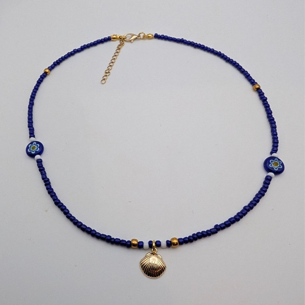 Blue glass beaded choker with seashell pendant and flower bead accents
