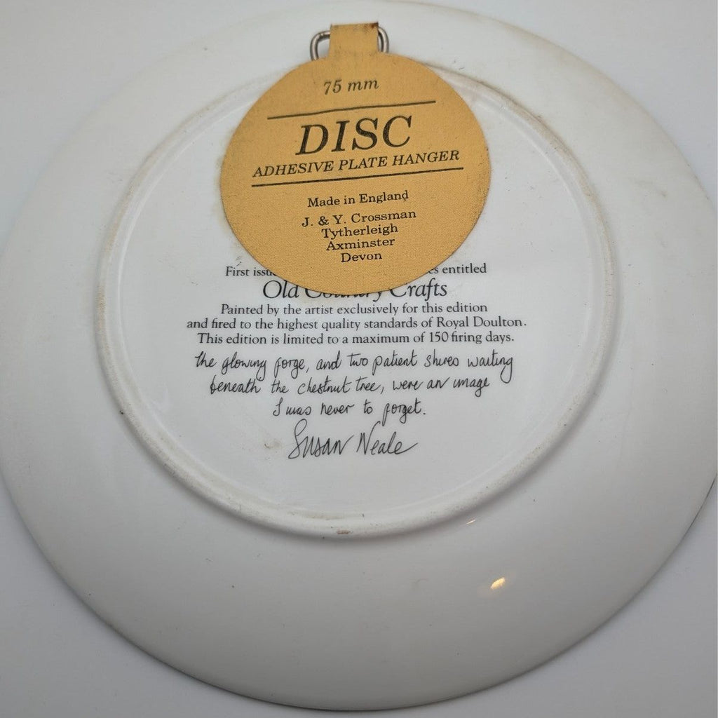 Collector plate back with hanging label and copyright text, round ceramic disc