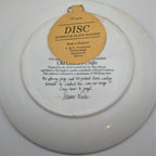 Collector plate back with hanging label and copyright text, round ceramic disc