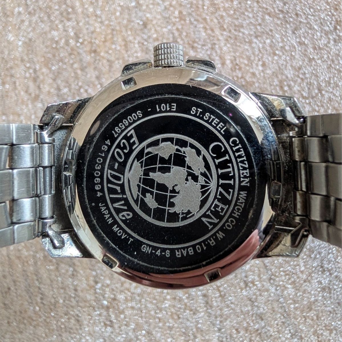 Military style watch case back close-up with Eco-Drive globe logo