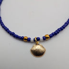 Blue glass beaded choker with gold seashell pendant and small spacer beads