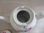 Porcelain teapot spout base interior, white with pink rose and green floral detail