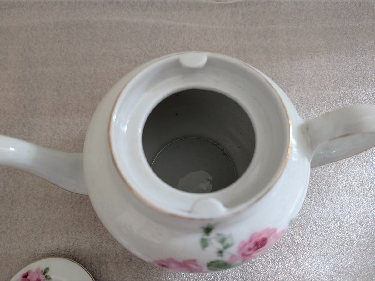 Porcelain teapot spout base interior, white with pink rose and green floral detail