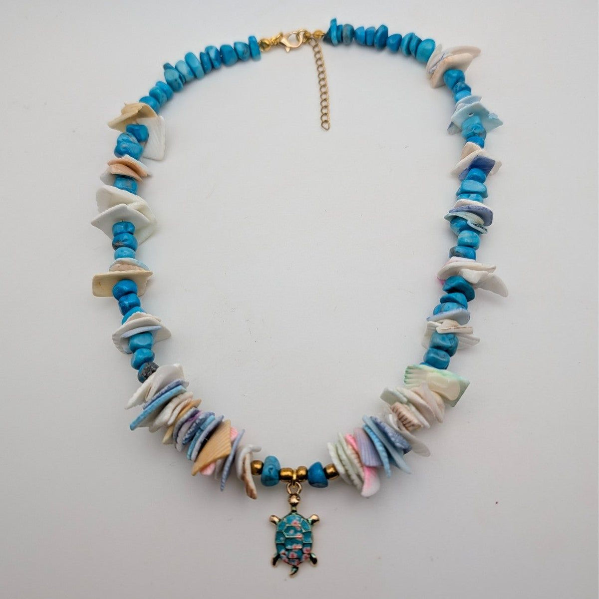 Turquoise and white shell beaded choker with turtle pendant