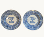 Pair of blue-and-white porcelain dinner plates, ornate urn border, 24 cm.