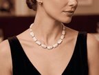 White pearl bead statement necklace with gold-tone links, oval beads