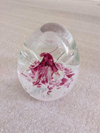 Glass paperweight with pink floral centerpiece and clear dome top