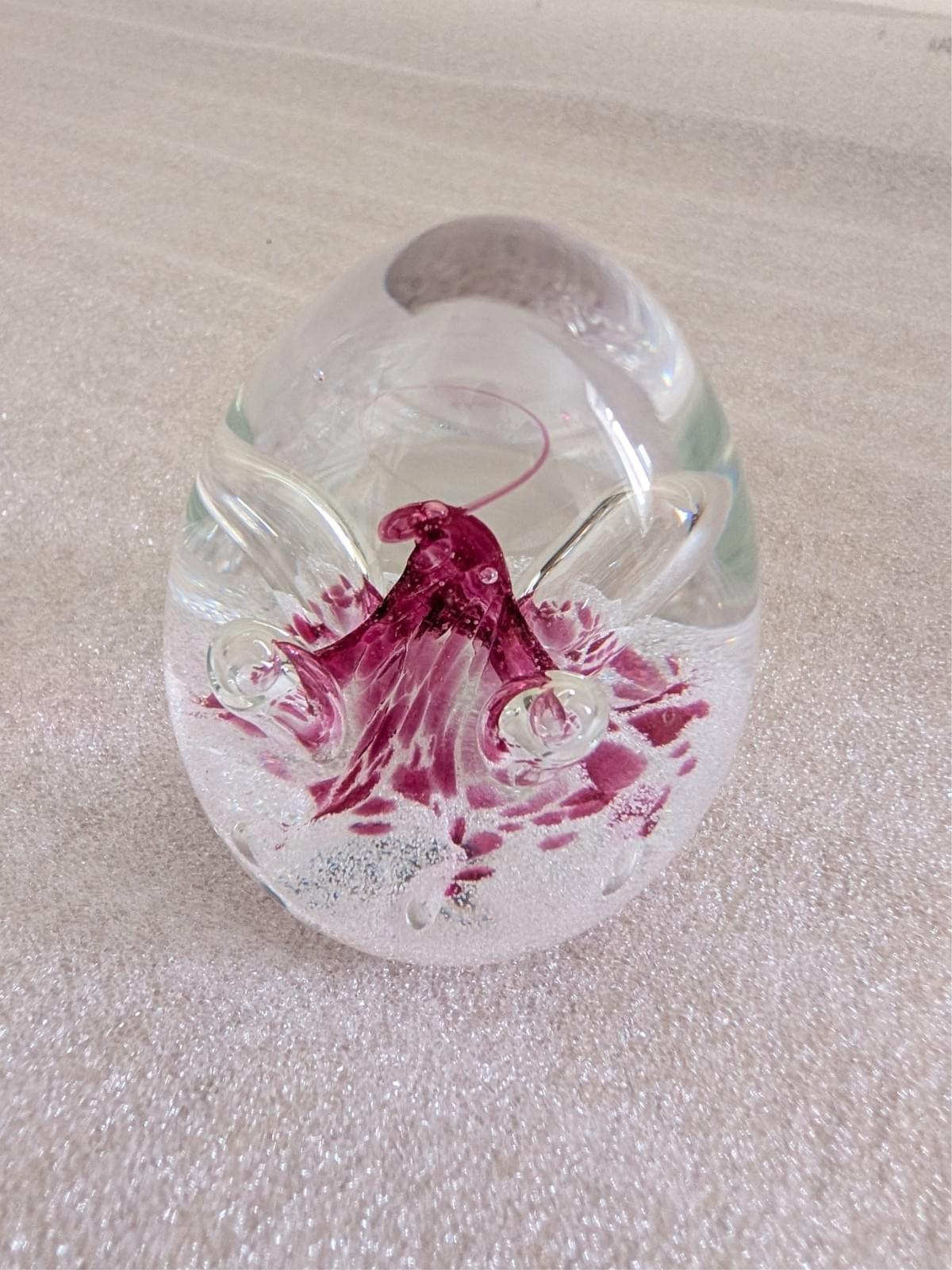Glass paperweight with pink floral centerpiece and clear dome top