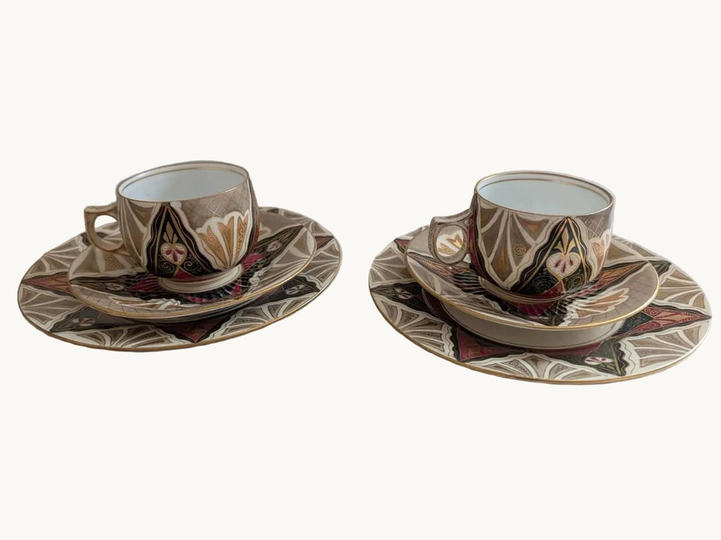 Porcelain tea cup and saucer with ornate multicolor band and floral motifs