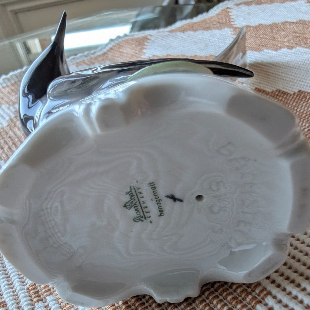 Porcelain bird figurine base underside view, molded detailing