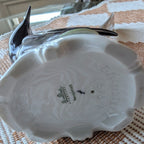 Porcelain bird figurine base underside view, molded detailing