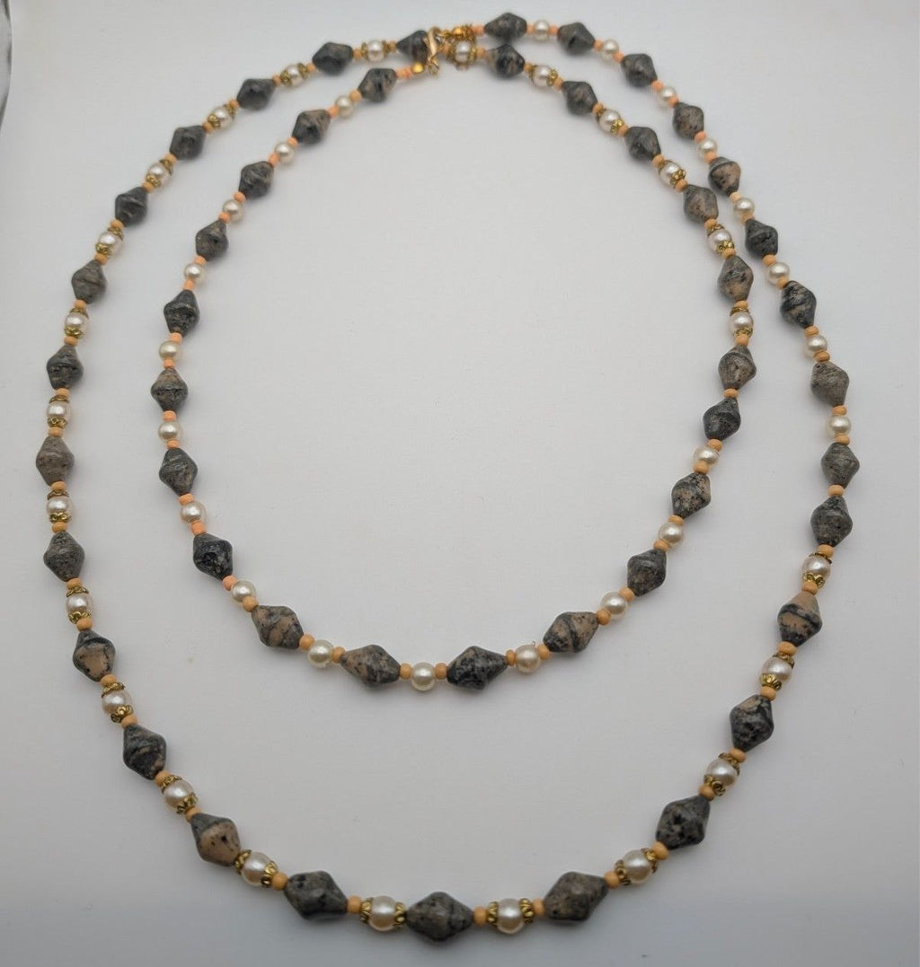 Long layered bead necklace with grey speckled stones and pearl-like beads