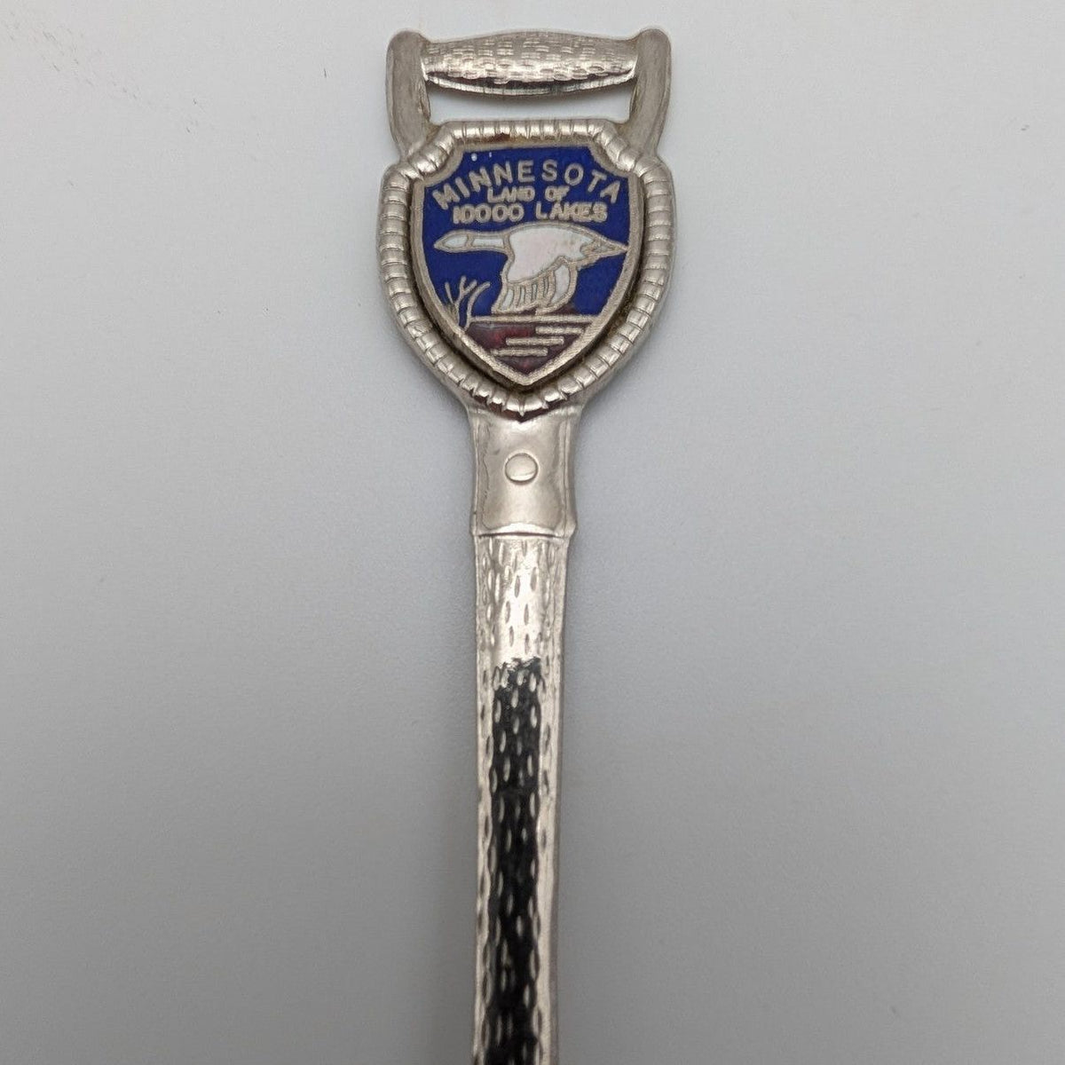 Shovel-shaped collector spoon with Minnesota 10000 lakes shield badge and blue loon graphic