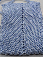 Light blue crochet phone bag with textured chevron stitch and crossbody strap